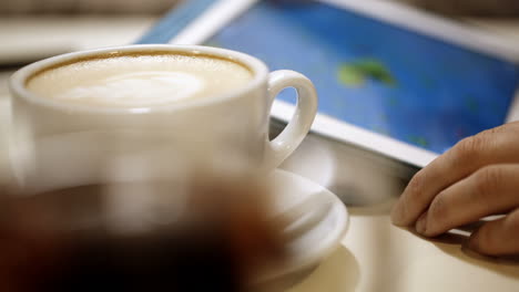 woman using touch pad during coffee break