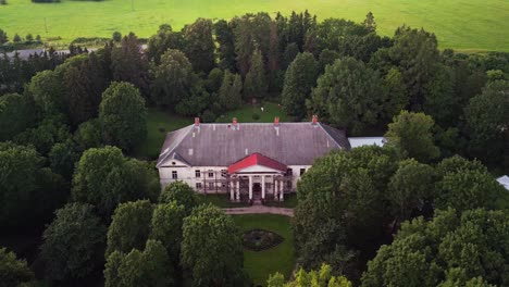 drone footage of kirna manor in järva county estonia showcases its elegant neoclassical architecture surrounded by peaceful parkland making it a unique cultural and historic landmark