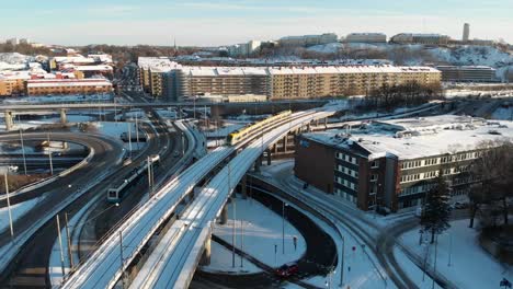 urban highway intersection with elevated railroad with train, downtown gothenburg at winter, sweden, aerial