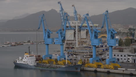 Container-port-with-moored-cargo-ship-in-coastal-city