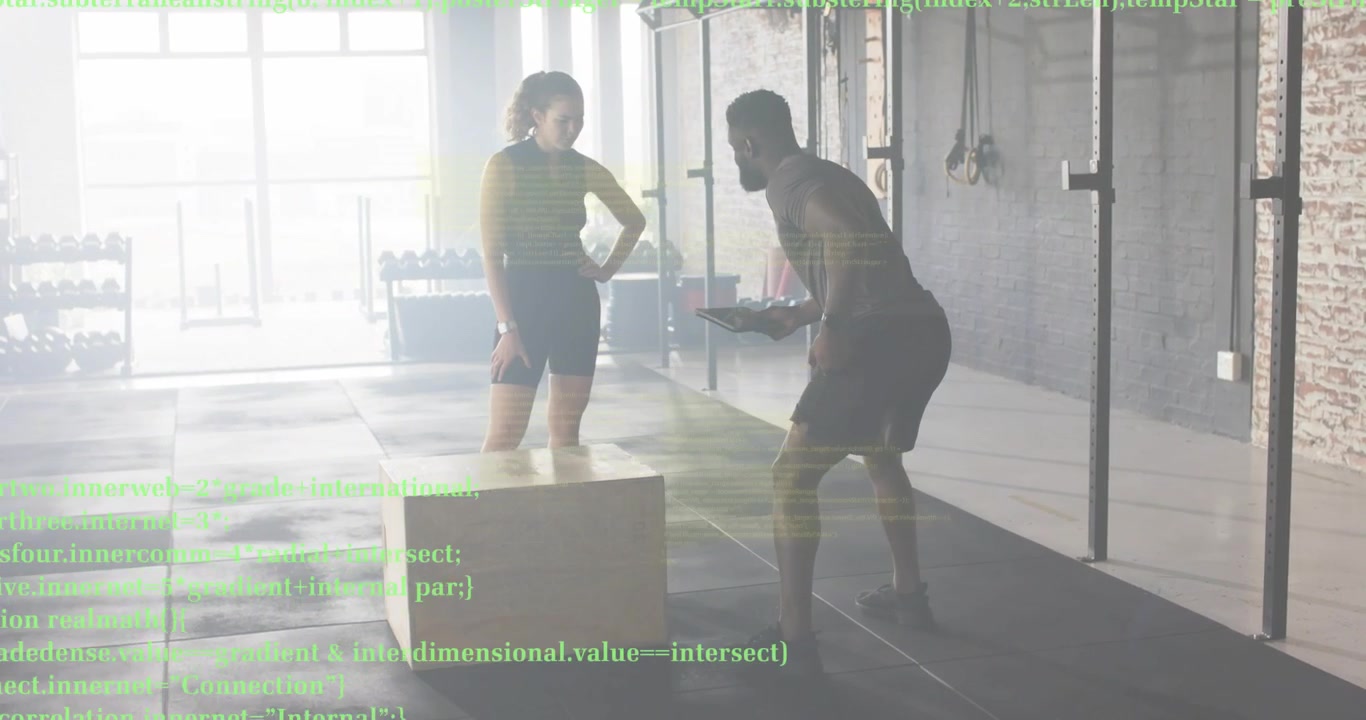 Fitness trainer gesturing toward box and counting client's box jumps while tracking tablet metrics