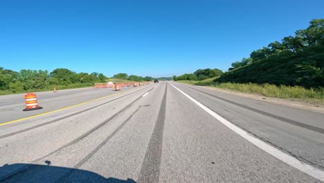 pov while driving on the avenue of the saints highway in rural iowa