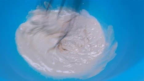 preparing creamy tahini sauce for falafel