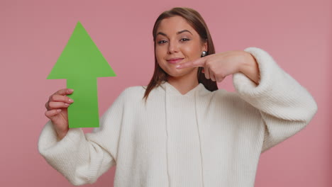 woman holding up arrow and giving thumbs up