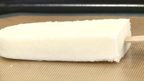white coconut popsicle on a baking sheet