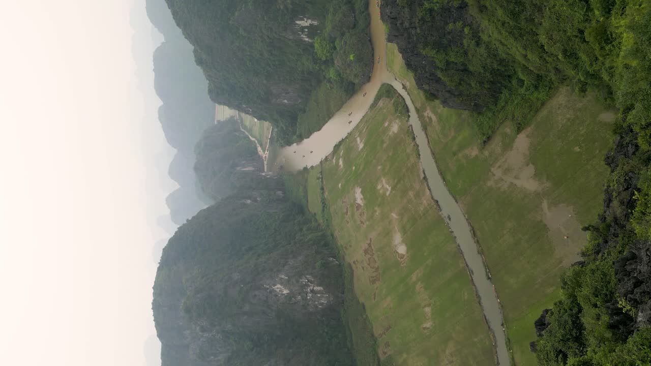 vertical shot of tourists taking photos with an oriental dragon at the Hang Mua
