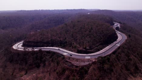ghat road with forest area and mountains, day time, push back, drone shot, 4k.
