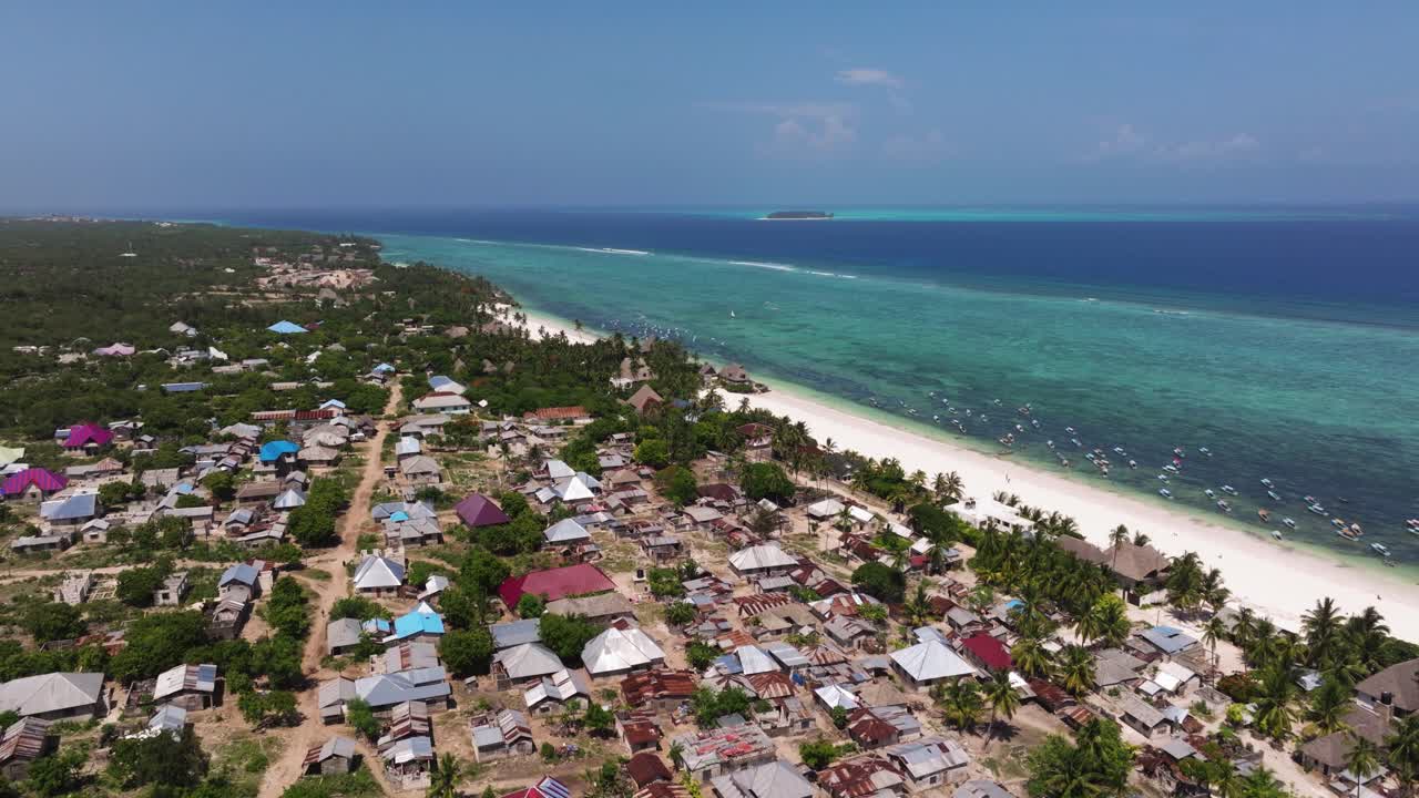 A coastal village in zanzibar, showcasing the beach and colorful houses, aerial view