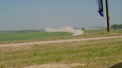 Sport-car-coming-from-afar-in-a-dust-cloud-driving-towards-the-camera-slow-motion