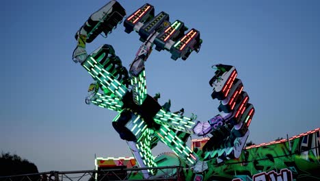 carnival ride spinning against a clear sky