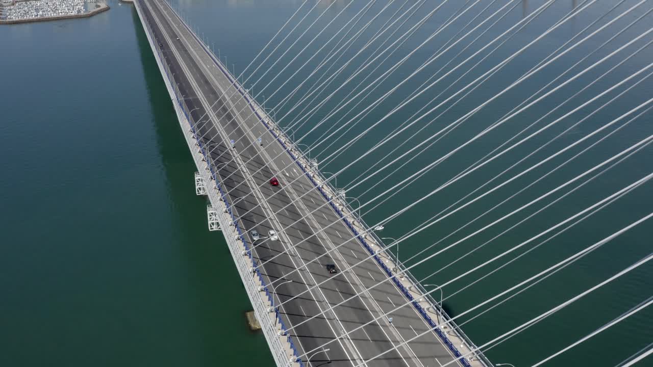 Aerial View of a Cable-Stayed Bridge over a Bay with Cityscape