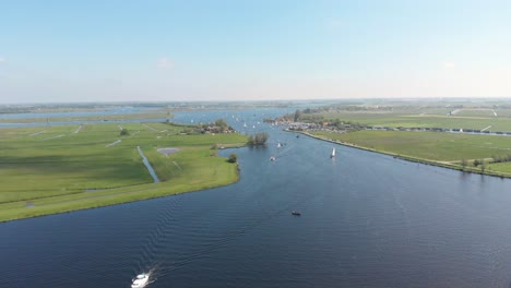 motorboats and sailboats on inland waterways, 4k aerial view on summer day