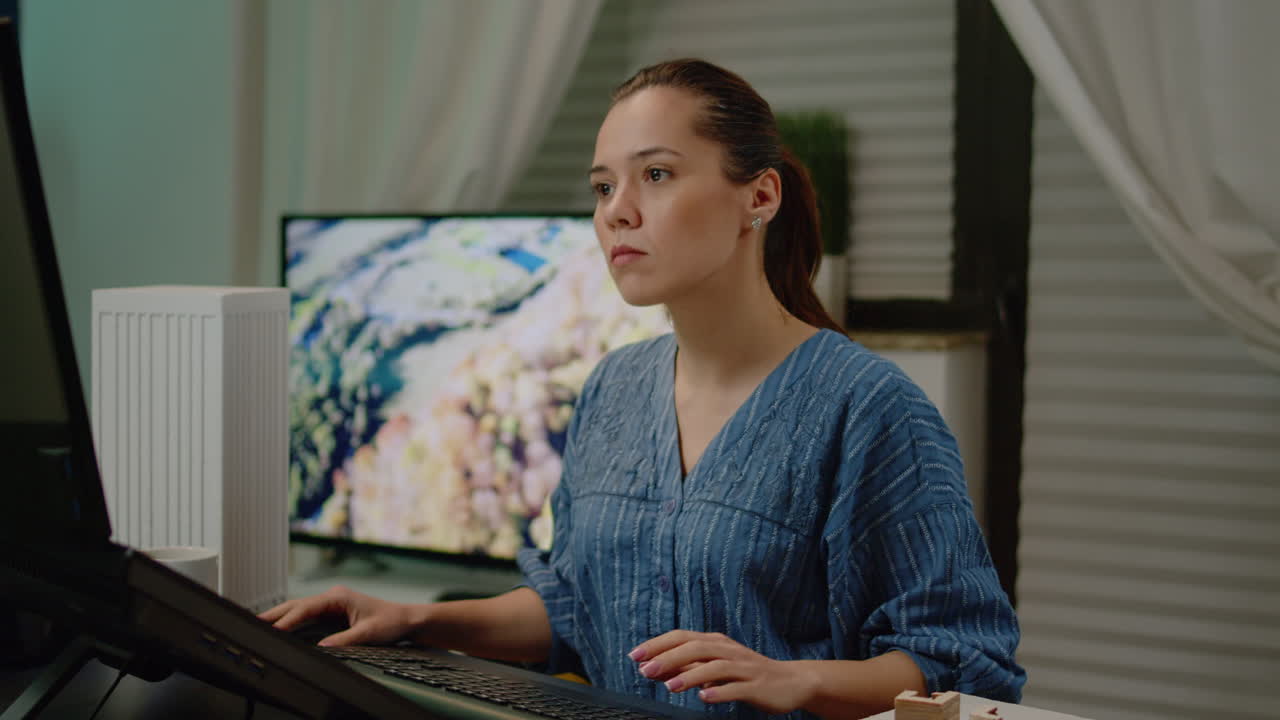 Woman architect using touch screen for building model