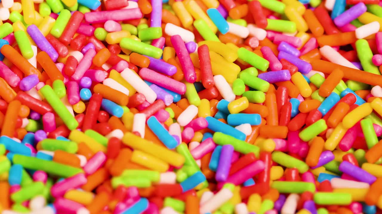 A dynamic close-up view of colorful sprinkles swirling in vibrant patterns.