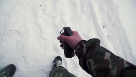 soldier holding a grenade in the snow