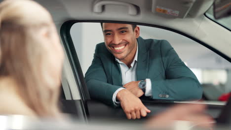car salesman handing over keys to customer