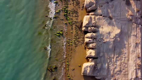 fly over beach sea line erosion rock mud mountain formation pattern of vivid scenic landform in a beautiful aerial coastal marine landscape for the water sport recreation tourist attraction in iran