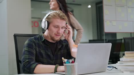 a young man listening to music indoors