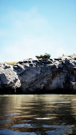 a cliff overlooking a calm river