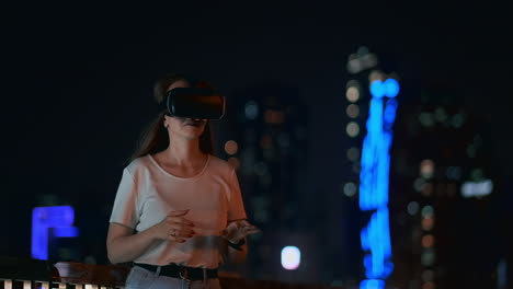 young girl simulated virtual reality work in glasses in modern big city at night on my lanterns and beautiful bokeh of passing cars and buildings