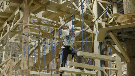 a child navigating an indoor rope course