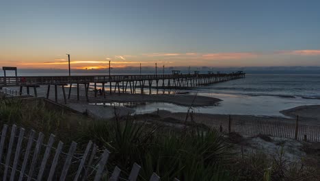 timelapse slider shot of bogue inlet fishing pier at sunrise - emerald isle, north carolina