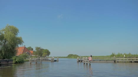 aproaching-a-pontoon-bridge-by-boat-in-the-summer-in-slow-motion