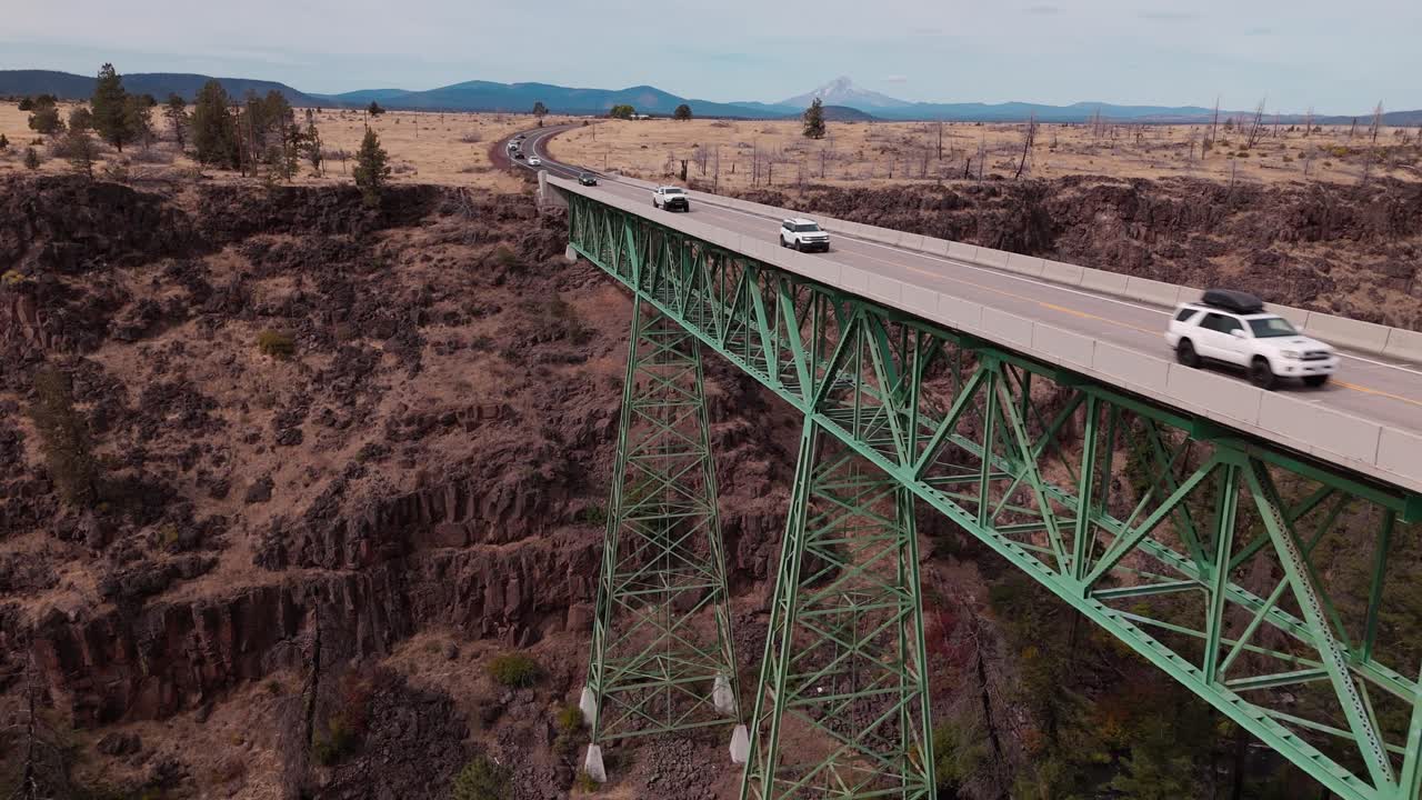 Aerial close approach of highway 26 and the bridge over Mill Creek in Warm Springs Oregon