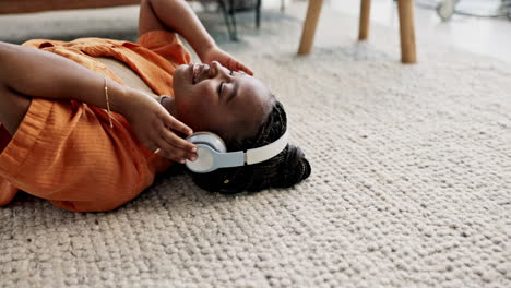 headphones, relax and young woman on the floor