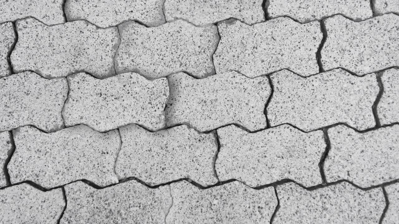 Wall of unevenly shaped rocks or slabs, one ”secret” rock pushed