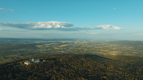 aerial view of a mountainous landscape with a church and fields