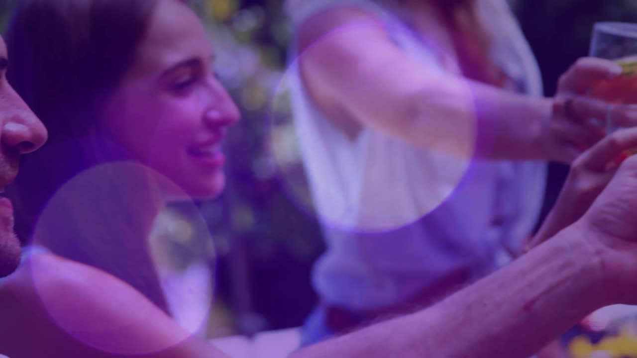 Woman reaching, friends clinking garnished drinks, purple bokeh overlaying then clearing for events