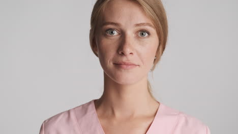 caucasian female doctor smiling on camera.