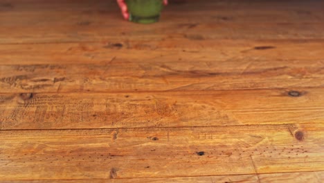 Detailed-shot-of-a-beautifully-presented-mojito-cocktail-placed-on-a-wooden-table-in-a-restaurant