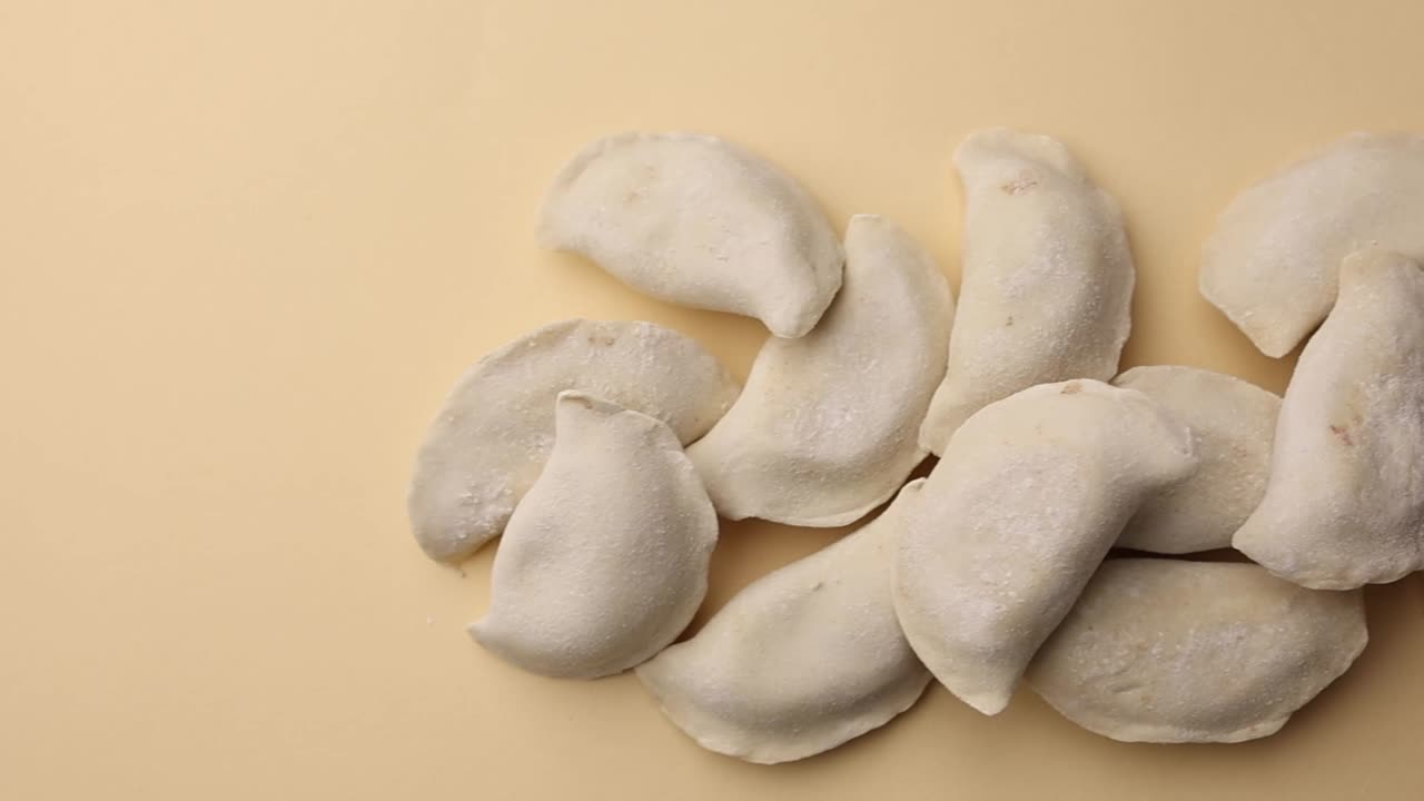 Frozen Dumplings on Beige Background