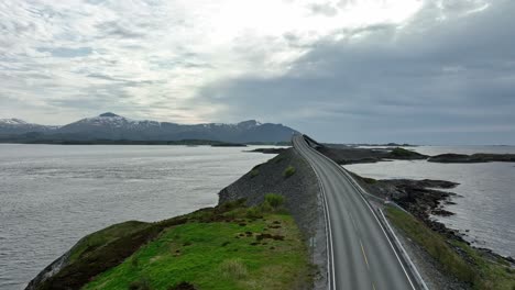 Atlantic-Ocean-Road-Norway---Evening-forward-moving-aerial-above-dark-road-with-bright-sky
