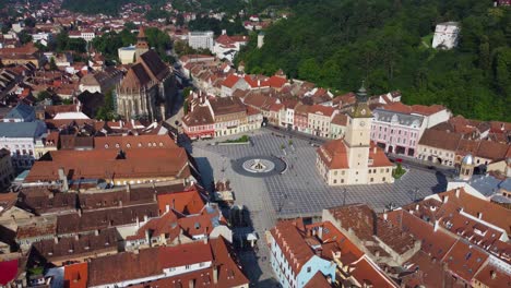 drone circling round brasov main square and town hall - romania