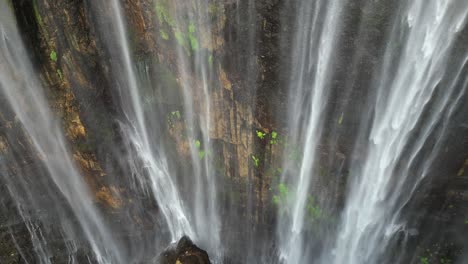 unique aerial view of wispy tumpak sewu waterfall grotto on java, idn