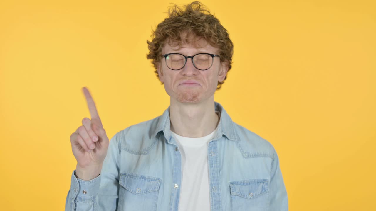 Redhead Young Man No Sign by Finger, Yellow Background