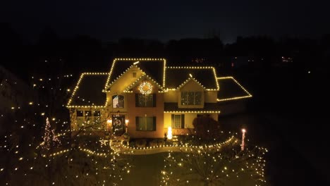 home with warm yellow christmas lights at night, festive atmosphere