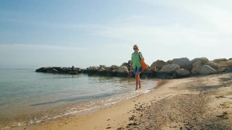 Steadicam-Shot-Woman-Walking-Along-The-Surf-Line-At-Amanecer