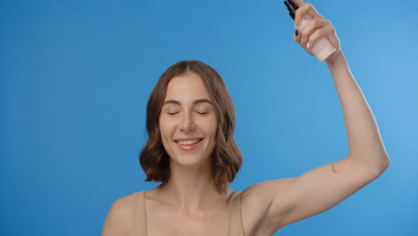 woman spraying skincare product