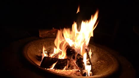 dazzling camp fire lights up the night in man made fire pit