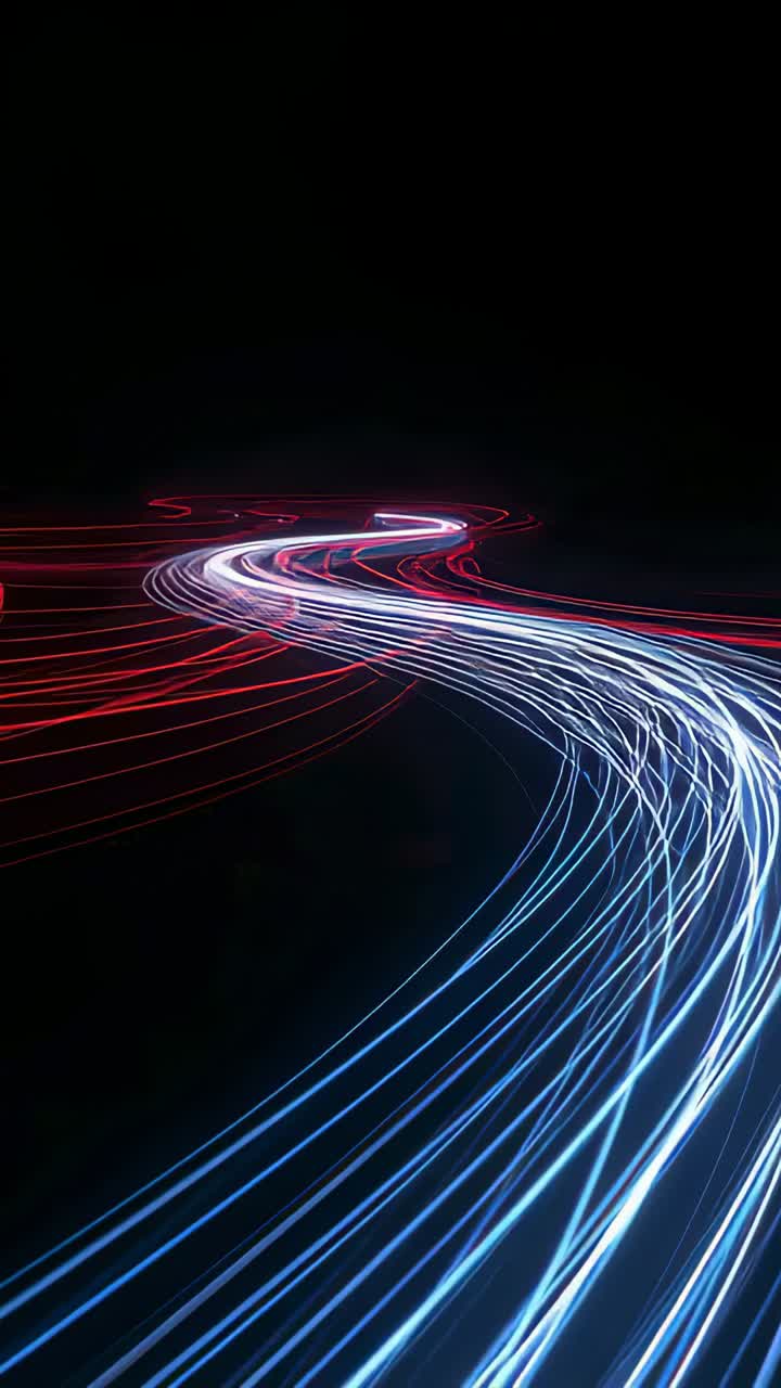 Video verticale: registrazione di sorgenti luminose in movimento che tracciano una curva a S in uno studio buio, creando scie