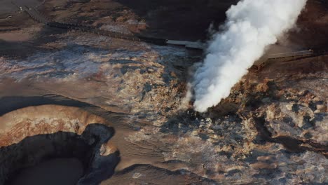 thick steam rises from volcanic fumarole in wild icelandic landscape, gunnuhver