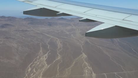 a shot from a plane flying over the andes mountains and the atacama desert