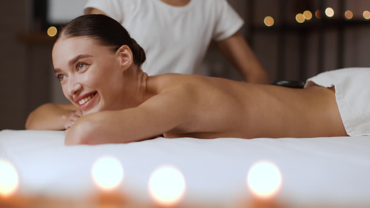Woman enjoying a hot stone massage at a spa