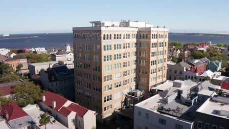 wide rising aerial shot of the people's office building, the lone skyscraper in charleston, south carolina