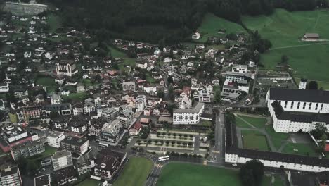 Drone-aerial-of-Cars-on-the-road-in-a-small-town-of-Endelberg-by-the-mountains-in-Switzerland