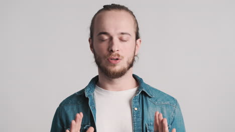 Caucasian-young-man-doing-breathing-exercises-on-camera.